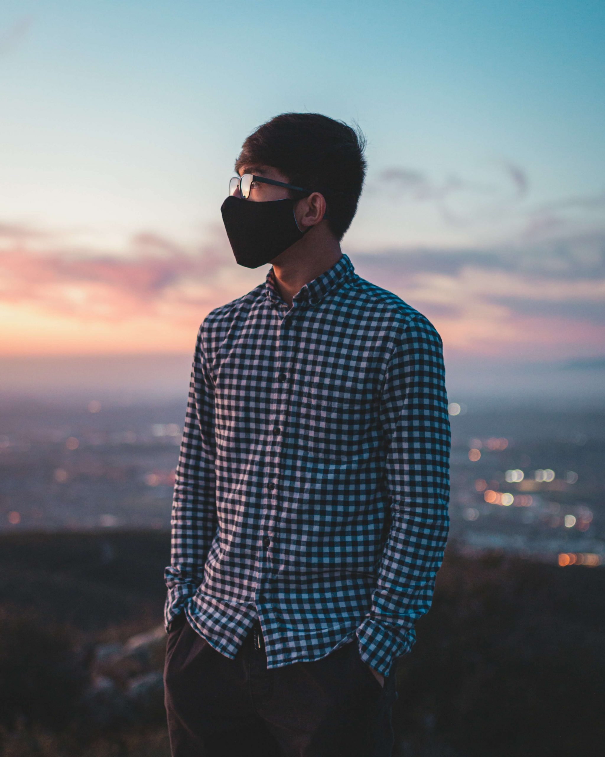 guy in mask overlooking hill