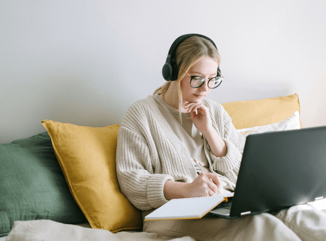 Girl quietly taking notes for her online degrees.