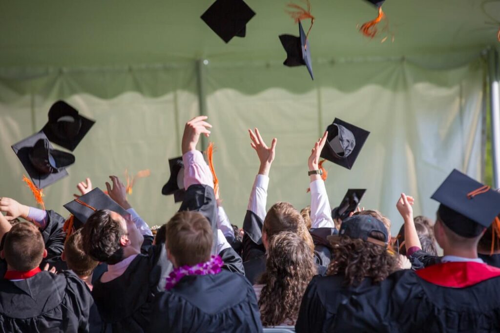 Graduates throwing their caps in the air.