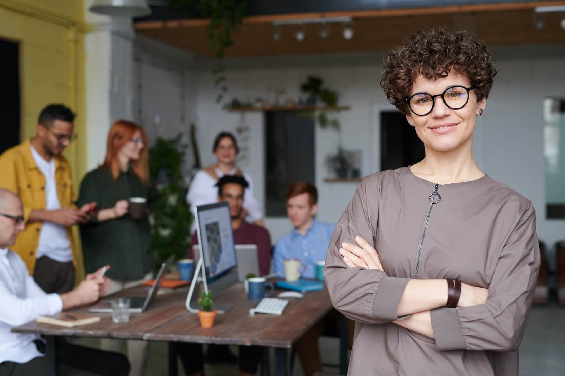 Employee standing in front of colleagues. 