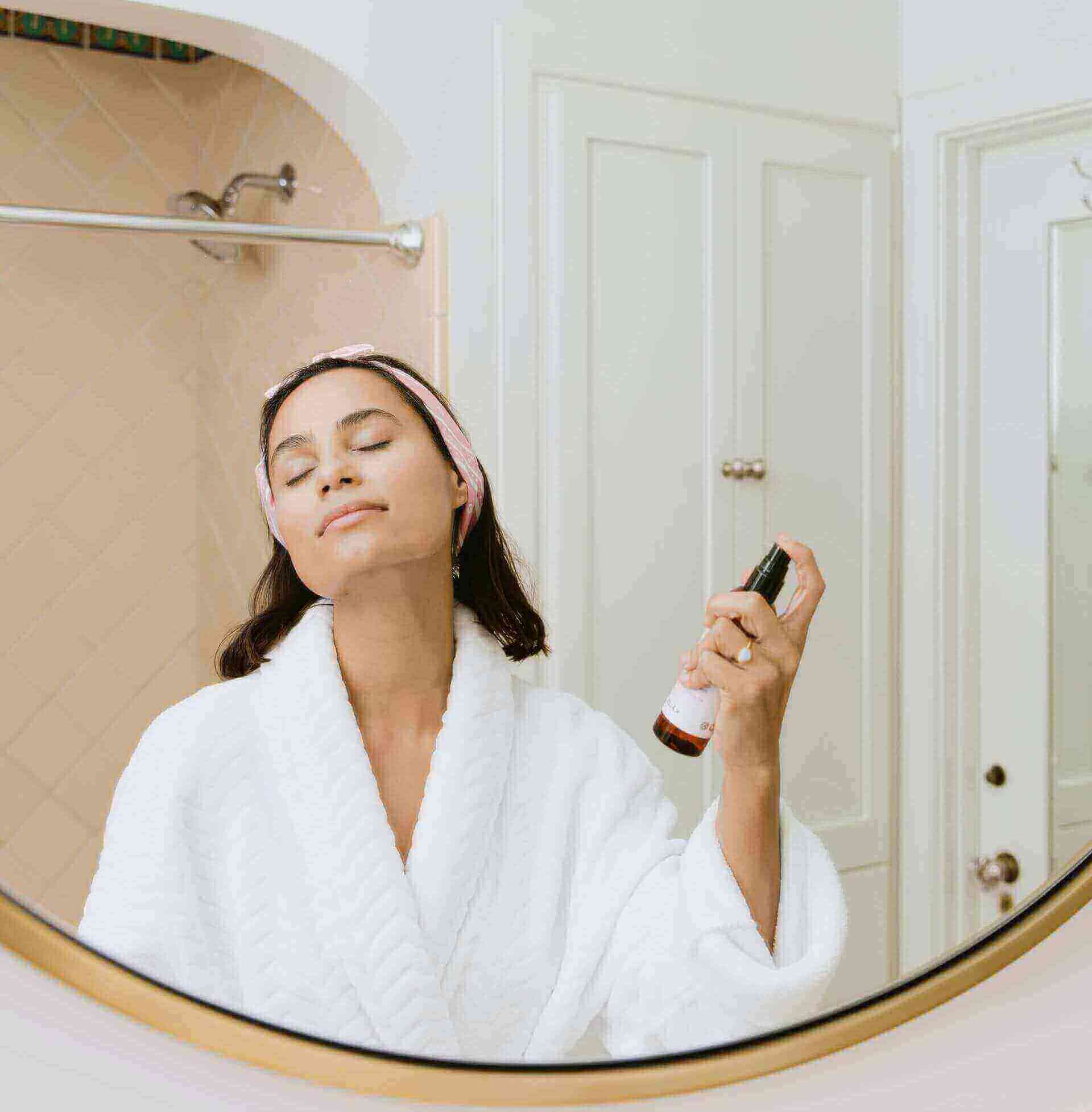 Girl in bathrobe doing skincare