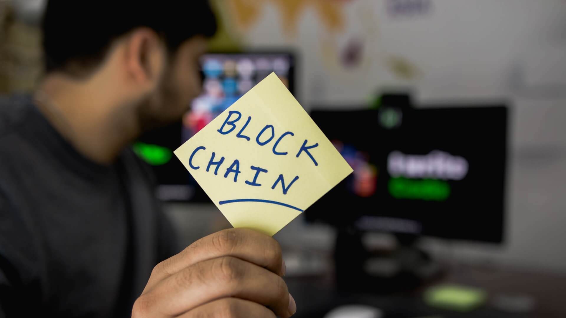 Yellow sticky note with the word blockchain.