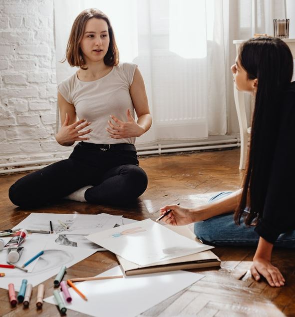 Two girls talking.