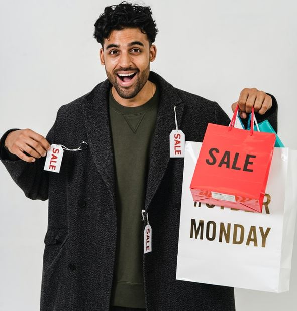 Guy holding shopping bags.