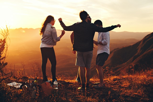 High school graduate with friends in nature.