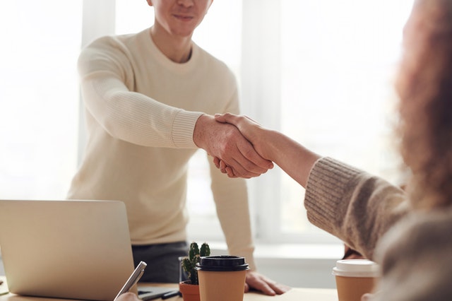 Man and woman shaking hands.