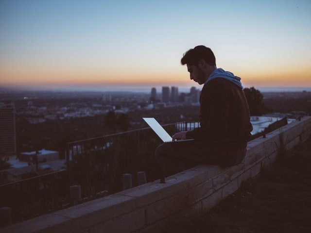 Foreign student looking for overseas jobs on laptop.