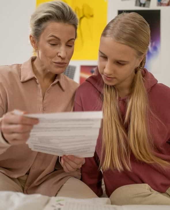 Mother and daughter checking offer letters.