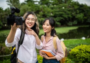 two teenagers taking a photo