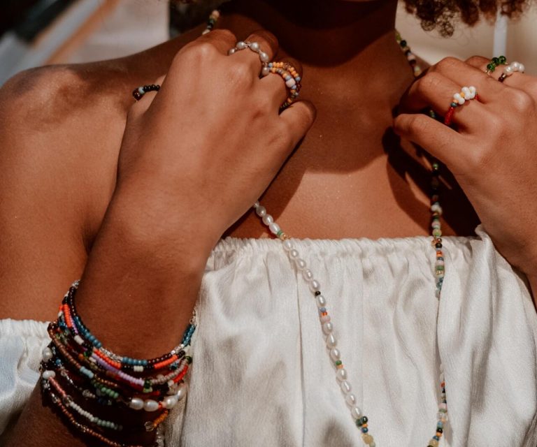 Woman wearing accessories on neck and hands.